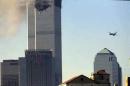 A plane, right, is seen moments before it crashes into the south tower of the World Trade Center in New York, Tuesday, Sept. 11, 2001. (AP Photo/Anthony Cotsifas) MANDATORY CREDIT; ONE-TIME USE ONLY