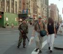 An armed military man patrols a street in downtown New York, Tuesday, Sept. 11, 2001. Mounting an attack against the United States, terrorists crashed two hijacked airliners into the World Trade Center and brought down the twin 110-story towers. (AP Photo/Boudicon One)