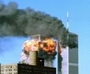 Smoke billows from the top of One World Trade Center and flames and debris explode from Two World Trade Center, Tuesday, Sept. 11, 2001, in New York. In one of the most horrifying attacks ever against the United States, terrorists crashed two airliners into the World Trade Center in a deadly series of blows that brought down the twin 110-story towers. (AP Photo/Kelley Sane)