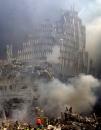 Firefighters make their way through the rubble after two airliners crashed into the World Trade Center in New York Tuesday, Sept. 11, 2001. (AP Photo/Shawn Baldwin)