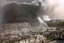 Firefighters fight a blaze amidst rubble after terrorists crashed two airliners into the World Trade Center in a deadly series of blows that brought down the twin 110-story towers in New York Tuesday, Sept. 11, 2001. (AP Photo/Shawn Baldwin)