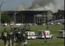 FBI agents head toward the Pentagon Tuesday, Sept. 11, 2001 as smoke billows from the building after a plane, reported hijacked and carrying a number of passengers, struck in midmorning in an apparent terrorist attack. (AP Photo/Steve Helber)