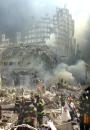 A shell of what was once part of the facade of one of the twin towers of New York's World Trade Center rises above the rubble that remains after both towers were destroyed in a terrorist attack Tuesday, Sept. 11, 2001. The 110-story towers collapsed after two hijacked airliners carrying scores of passengers slammed into the sides of the twin symbols of American capitalism. (AP Photo/Shawn Baldwin)