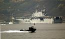 RETRANSMISSION TO UPDATE OBJECT NAME--Small U.S. Navy boats patrol San Diego Bay as the amphibious assault ship, the U.S.S. Belleau Wood heads out into the Pacific Tuesday, Sept. 11, 2001 in San Diego.  All San Diego area military bases were put a heightened state of alert following the terrorist attacks on New York and Washington. The Navy is not releasing details on ship movements.  (AP Photo/Denis Poroy)