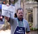 Adrian Pierce, an employee of the Knoxville News-Sentinel, stands on a street corner of Market Square in downtown Knoxville, Tenn., selling extra editions of the newspaper Tuesday, Sept. 11, 2001 after terrorists attacked the World Trade Center earlier in New York. Newspapers in Chattanooga, Jackson and Knoxville, Tenn., produced extra editions. (AP Photo/Wade Payne)