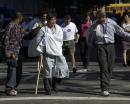 An unidentified injured man is assisted outside Beth Israel Hospital in New York Tuesday, Sept. 11, 2001. The man said he was outside the World Trade Center towers when they collapsed after being struck by planes. (AP Photo/Amy Sancetta)