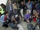 Members of the media watch the latest developments on a small monitor outside Los Angeles International Airport where they were asked to wait after the airport was shut down, Tuesday, Sept. 11, 2001. In one of the most horrifying attacks ever against the United States, terrorists crashed two airliners into the World Trade Center in a deadly series of blows Tuesday that brought down the twin 110-story towers. A plane also slammed into the Pentagon as the government itself came under attack.  (AP Photo/Nick Ut)