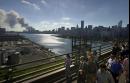 Pedestrians cross the 59th Street Bridge from Manhattan to Queens as smoke billows from the remains of the twin towers of the World Trade Center in New York, Tuesday, Sept. 11, 2001. (AP Photo/Lawrence Jackson)