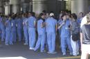 Medical students stand outside the NYU Medical Center on the eastside of Manhattan, New York, Tuesday, Sept. 11, 2001. They were waiting for potential large numbers of injured from the collapse of the World Trade Center towers.  (AP Photo/Amy Sancetta)