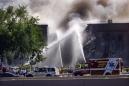 Firefighters from various Northern Virginia communities help fight a fire the Pentagon Tuesday, Sept. 11, 2001, after the building took a direct hit from an aircraft. (AP Photo/Hillery Smith Garrison)