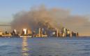 Smoke rises from the remains of the twin towers of the World Trade Center as the sun sets in New York, Tuesday, Sept. 11, 2001.  In the most devastating terrorist onslaught ever waged against the United States, hijackers crashed two airliners into the World Trade Center on Tuesday, toppling its twin 110-story towers. (AP Photo/Stuart Ramson)