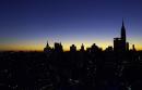 The sun sets over the New York City skyline and the Empire State Building, right, Tuesday, Sept. 11, 2001. Gone from the famous view is the two towers of the World Trade Center, they were destroyed by a terrorist attack early Tuesday morning. (AP Photo/Beth A. Keiser)