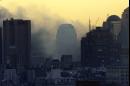 The evening sky turns yellow at sunset Tuesday, Sept. 11, 2001, as smoke continues to rise from the hole in the skyline of New York City where the World Trade Center towers stood until Tuesday morning. The World Trade Center was destroyed by a terrorist attack early Tuesday morning. (AP Photo/Beth A. Keiser)