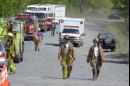 An ambulance drives behind two firemen as they walk along the road near the crash scene of a United Airlines jet that crashed near Shanksville, Pa., Tuesday, Sept. 11, 2001. (AP Photo/Keith Srakocic)