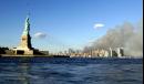 The Statue of Liberty, left, stands in New York Harbor as columns of smoke rise from the site of the World Trade Center in lower Manhattan, New York, Tuesday, Sept. 11, 2001. (AP Photo/Jeff Zelevansky)