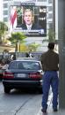 Tom Dillon, of Los Angeles, watches, from the sunset strip in Los Angeles, a live large-screen projection of President Bush addressing the nation following attacks in New York, Washington, and Pittsburgh Tuesday, Sept. 11, 2001. (AP Photo/E.J. Flynn)