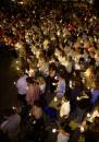 Some of the approximately 500 people attending an interfaith prayer service hold candles on the campus of the University of Wisconsin on Tuesday, Sept. 11, 2001, in Madison, Wis., after the attacks on New York and the Pentagon earlier Tuesday. (AP Photo/Andy Manis)