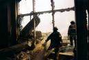 Firefighters make their way through the blown out facade of a World Financial Center building as they head in the direction of the destroyed towers of New York's World Trade Center, following a terrorist attack that leveled the twin towers in lower Manhattan, Tuesday, Sept. 11, 2001. (AP Photo/Alex Fuchs)