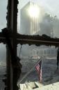 A solitary American flag hangs against the backdrop of debris that was once the World Trade Center in New York Tuesday, Sept. 11, 2001. Planes crashed into the upper floors of both World Trade Center towers minutes apart Tuesday morning, collapsing both 110-story buildings. (AP Photo/Graham Morrison)