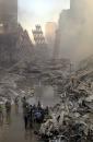 Emergency personnel gather at the site of the World Trade Center in New York, Tuesday, Sept. 11, 2001. Two planes crashed into the upper floors of both World Trade Center towers minutes apart Tuesday morning, collapsing the 110-story buildings. (AP Photo/Graham Morrison)