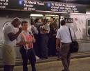 People wait as a downtown subway train sits idle in New York Tuesday, Sept. 11, 2001. Two planes crashed into the upper floors of both World Trade Center towers minutes apart Tuesday morning, collapsing the 110-story buildings and disrupting transportation throughout the area. (AP Photo/David Gochfeld)