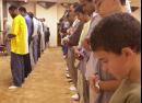 Muslim worshippers pray during the evening prayer service at the Islamic Center of Southern California, in Los Angeles, Tuesday evening, Sept. 11, 2001. Religious leader Dr. Hassan Hathout, far left, delivered an elegy for the victims of this morning's terrorist attacks and called upon fellow Americans to stand together to bring the perpetrators to justice.  (AP Photo/Ric Francis)