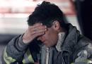 A New York City firefighter takes a break at a command center truck near Stuyvesant High School, blocks from the site of the World Trade Center in New York, in the early hours of Wednesday, Sept. 12, 2001. (AP Photo/ Victoria Arocho)