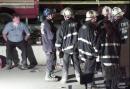 New York City firefighters gather near Stuyvesant High School, blocks from the site of the World Trade Center in the early hours of Wednesday, Sept. 12, 2001. Rescue operations continued during the night at the scene of the disaster. (AP Photo/ Victoria Arocho)