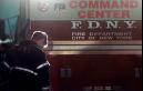 A New York City firefighter pauses at the back of a fire department command center truck near Stuyvesant High School blocks from the site of the World Trade Center in the early hours Wednesday, Sept. 12, 2001, as rescue operations continued. (AP Photo/ Victoria Arocho)