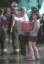 One volunteer directs another where to give out sandwiches, near Stuyvesant High School as rescue operations continued through the night at the site of the World Trade Center, Wednesday, Sept. 12, 2001. (AP Photo/ Victoria Arocho)