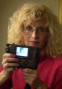 Carmen Taylor, of Ft. Smith, Ark., poses with her digital camera in New York on Tuesday, Sept. 11, 2001. Sightseeing on a Manhattan vacation with her son's digital camera, Taylor photographed the second airliner's crash into the World Trade Center earlier in the day. One photograph showed the plane at an angle just before impact (shown in camera); a second showed an explosion shortly after the plane pierced the building's side. (AP Photo/Robert Bukaty)