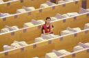 A lone stock runner observes a stock price monitor Wednesday, Sept. 12, 2001 at the Shanghai Stock Exchange in Shanghai. China stocks plunged at the opening bell but managed to cut their losses during the morning trading following reports of terrorist attacks in the United States. (AP Photo/Eugene Hoshiko)