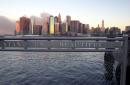 A sign on the Brooklyn side of the East River frames the skyline of Manhattan without the World Trade Center towers, as seen from the Brooklyn borough of New York, early Wednesday, Sept. 12, 2001. Terrorists crashed two planes into the World Trade Center Tuesday, causing the twin 110-story towers to collapse. (AP Photo/Kathy Willens)