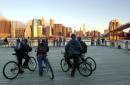 Workers on bicycles pause to look at the Manhattan skyline without the World Trade Center towers, from the Brooklyn borough of New York, early Wednesday, Sept. 12, 2001. Terrorists crashed two planes into the World Trade Center Tuesday, causing the twin 110-story towers to collapse. (AP Photo/Kathy Willens)