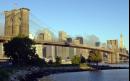 Smoke rises behind the Brooklyn Bridge over the East River frames the skyline of Manhattan, minus the World Trade towers, as seen from Brooklyn early Wednesday, Sept. 12, 2001, the day after hijacked airplanes crashed into both buildings causing their collapse Tuesday. (AP Photo/Kathy Willens)