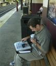 Jerry Ribero of New York reads about the World Trade Center terrorist attack in the The New York Times as he waits for a train to New York on a nearly empty platform at the Metropark station in Edison, N.J. Wednesday, Sept. 12, 2001. Commuters and train conductors at the normally busy station said there were far fewer people taking the trains towards New York Wednesday morning. Ribero, who lives about a mile from the World Trade Center, stayed with a friend last night because he couldn't get home from his job in White Plains, N.Y. (AP Photo/Daniel Hulshizer)