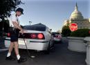 In the wake of Tuesday's terrorist attacks, U.S. Capitol Police officer Scot Humphrey uses a mirror to check underneath the car driven by the deputy police chief of his own force, at sunrise, Wednesday, Sept. 12, 2001, in Washington. Humphrey said it was the first day in his 16-year-career on Capitol Hill when he was instructed at roll call to search all vehicles, even those driven by his own commanders. (AP Photo/Kenneth Lambert)