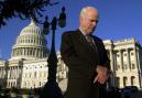 In the wake of Tuesday's terrorist attacks, Sen. John McCain, R-Ariz., returned to work, waiting outside the Capitol to give a television interview, Wednesday, Sept. 12, 2001, in Washington. (AP Photo/Kenneth Lambert)