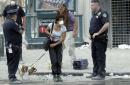 A couple evacuate their pets from the area near the World Trade Center Wednesday morning, Sept 12, 2001, in New York. Police allowed people into the closed off section downtown to go home and get their pets. (AP Photo/Amy Sancetta)