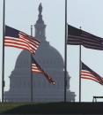 With the Capitol in the background, flags fly at half-staff on the Washington Monuments grounds Wednesday, Sept. 12, 2001 in honor of lives lost in the terrorist attacks at the Pentagon and at the World Trade Center in New York. (AP Photo/Joe Marquette)