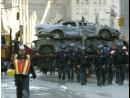 Crushed cars are hauled away as a group of rescue workers walk down the street near the World Trade Center attack site Wednesday Sept. 12, 2001.  A terrorist attack collapsed the twin towers of the World Trade Center Tuesday.(AP Photo/Amy Sancetta)