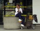 Pamela Williams of Tampa, Fla., waits for a flight home outside the locked doors at Hartsfield Atlanta International Airport Wednesday, Sept. 12, 2001. Hartsfield was closed after air travel was suspended in the United States following terrorist attacks in New York and Washington Tuesday. (AP Photo/John Bazemore)