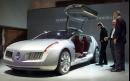 Three men inspect a Renault concept car named Talisman at the international motor show in Frankfurt, Germany, Wednesday, Sept.12, 2001. The luxurious sports coupe by the French auto maker is a four-seater with just one large gull-wing door on each side. (AP Photo/Frank Rumpenhorst)