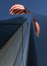 A flag flies at half-staff Wednesday, Sept. 12, 2001 next to the Sears Tower in Chicago. The building was open to workers Wednesday, a day after the U.S. was rocked by terrorist attacks in New York and Washington, D.C., but workers faced heavy security. (AP Photo/Ted S. Warren)