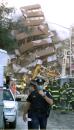 A police officer adjusts his face mask as he walks away from debris near the site of the World Trade Center, Wednesday, Sept. 12, 2001 in New York. Two hijacked airliners crashed into the  towers on Tuesday, Sept. 11, destroying both buildings. (AP Photo/Richard Drew)