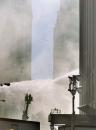 Firefighters spray water onto buildings near the site of the World Trade Center, Wednesday, Sept. 12, 2001 in New York. Two hijacked airliners crashed  into the  towers on Tuesday, Sept. 11, destroying both buildings. (AP Photo/Richard Drew)