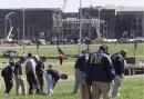 FBI agents search the area outside the Pentagon in Washington D.C., Wednesday Sept. 12, 2001, as they try and find clues in Tuesday's plane crash into the Pentagon. A construction crane in background helps with recovery efforts. (AP Photo/Ron Edmonds)