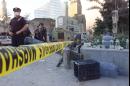 New York City police officers guard a police line near the Stuyvesant High School bridge near the site of the World Trade Center attack, Wednesday, Sept. 12, 2001, in New York. (AP Photo/Victoria Arocho)