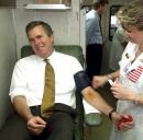 Florida Gov. Jeb Bush smiles as nurse Susan Church prepares the Governor's arm for his blood donation on Wednesday, Sept. 12, 2001 in Tallahassee, Fla. Bush was donating to the Southeast Community Blood Center that had set up a blood mobile at the Capitol courtyard.    (AP Photo/Phil Coale)