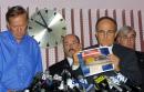 New York Gov. George Pataki, left, Police Commissioner Bernard Kerik, center rear, and Barry Mawn, head of the the New York office of the FBI, rear right, stand behind New York Mayor Rudy Giuliani as Giuliani holds up a photo of an airliner flight recorder, known as a 'black box,' as he appeals to the public in New York, Wednesday, Sept. 12, 2001, for help in locating the devices carried on the planes that crashed into the World Trade Center on Tuesday. (AP Photo/David Karp)